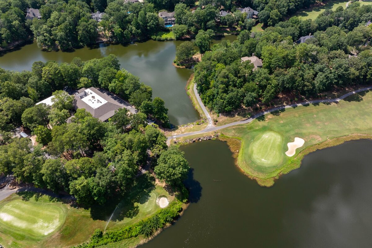 Aerial view of a lakeside green in Riverchase East with homes fronting the water